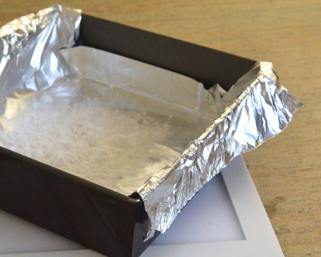 Lining a baking tray with foil ready to clean silver